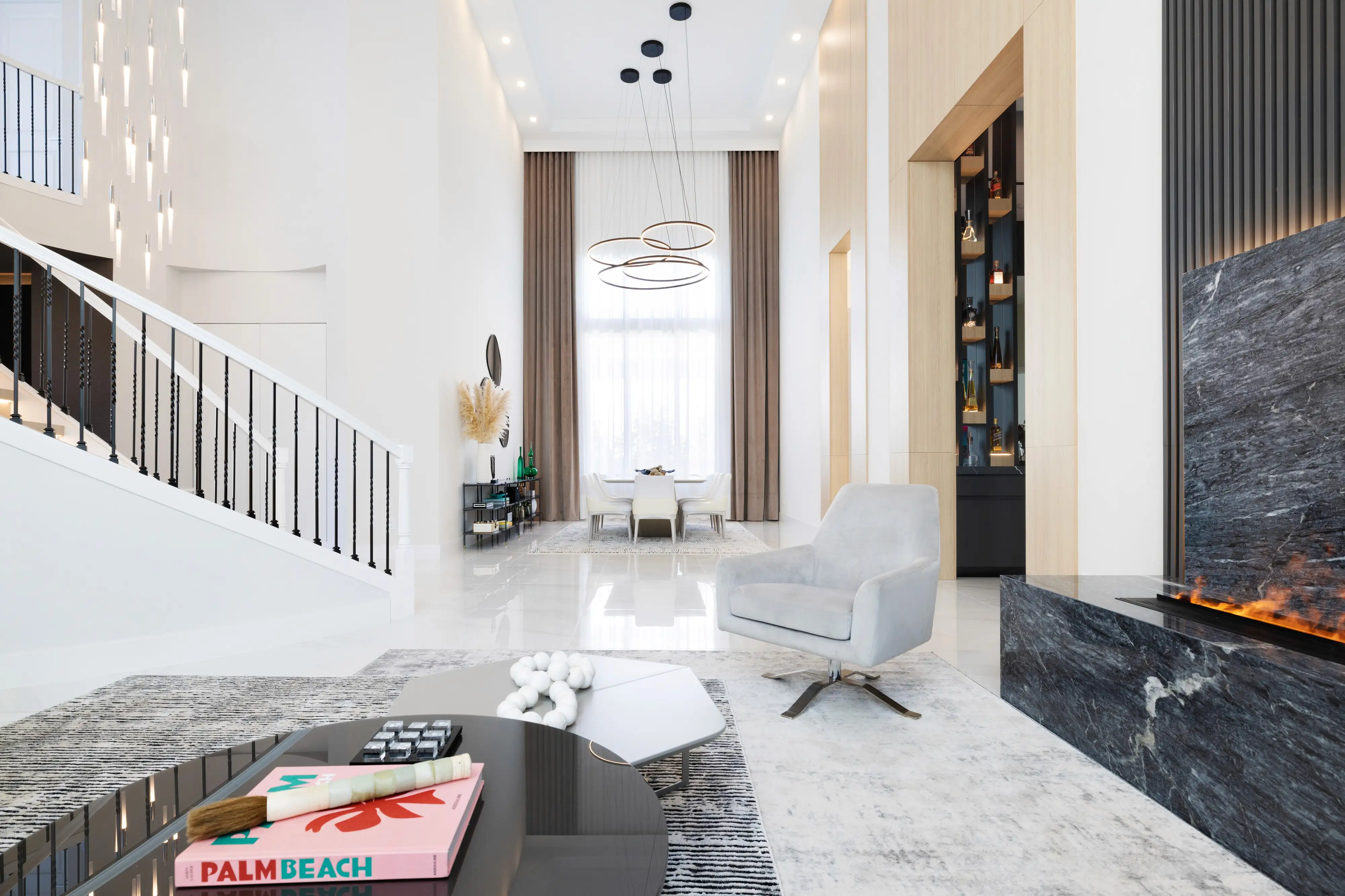 Double-height great room in a Boca Raton estate with timber beams and limestone floors