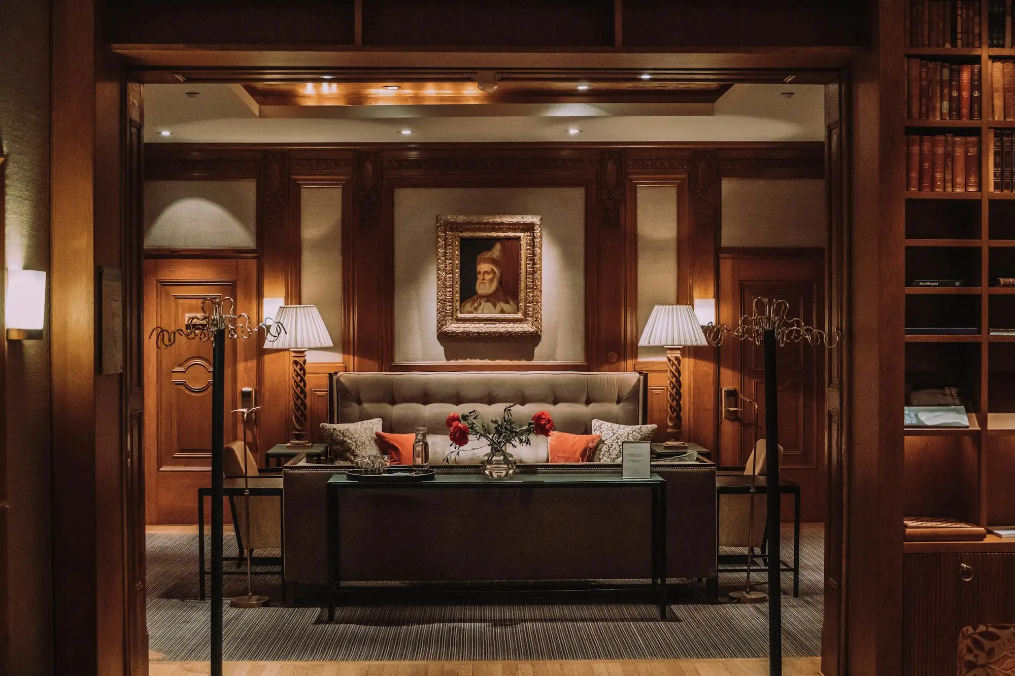 Boutique hotel lounge in Miami with warm layered lighting and custom banquette seating